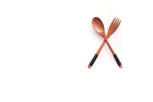 wooden cutlery fork and spoon on a chopping board on table photo