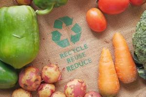 Recycled arrows sign on a shopping bag with vegetable photo