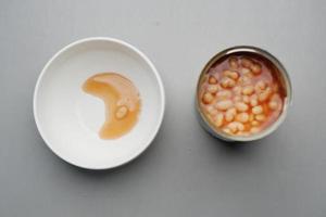 preserved canned tomato beans on table photo