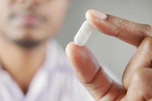 Close up of man hand holding pills with copy space photo