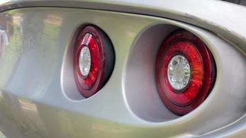 Large, red, round taillights of a racing modern sports car. video