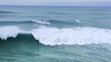 Jet skis in the water and surfers waiting for the big waves in Nazare, Portugal. Biggest waves in the world. Touristic destination for surfing and lovers of radical sports. Amazing destinations. video