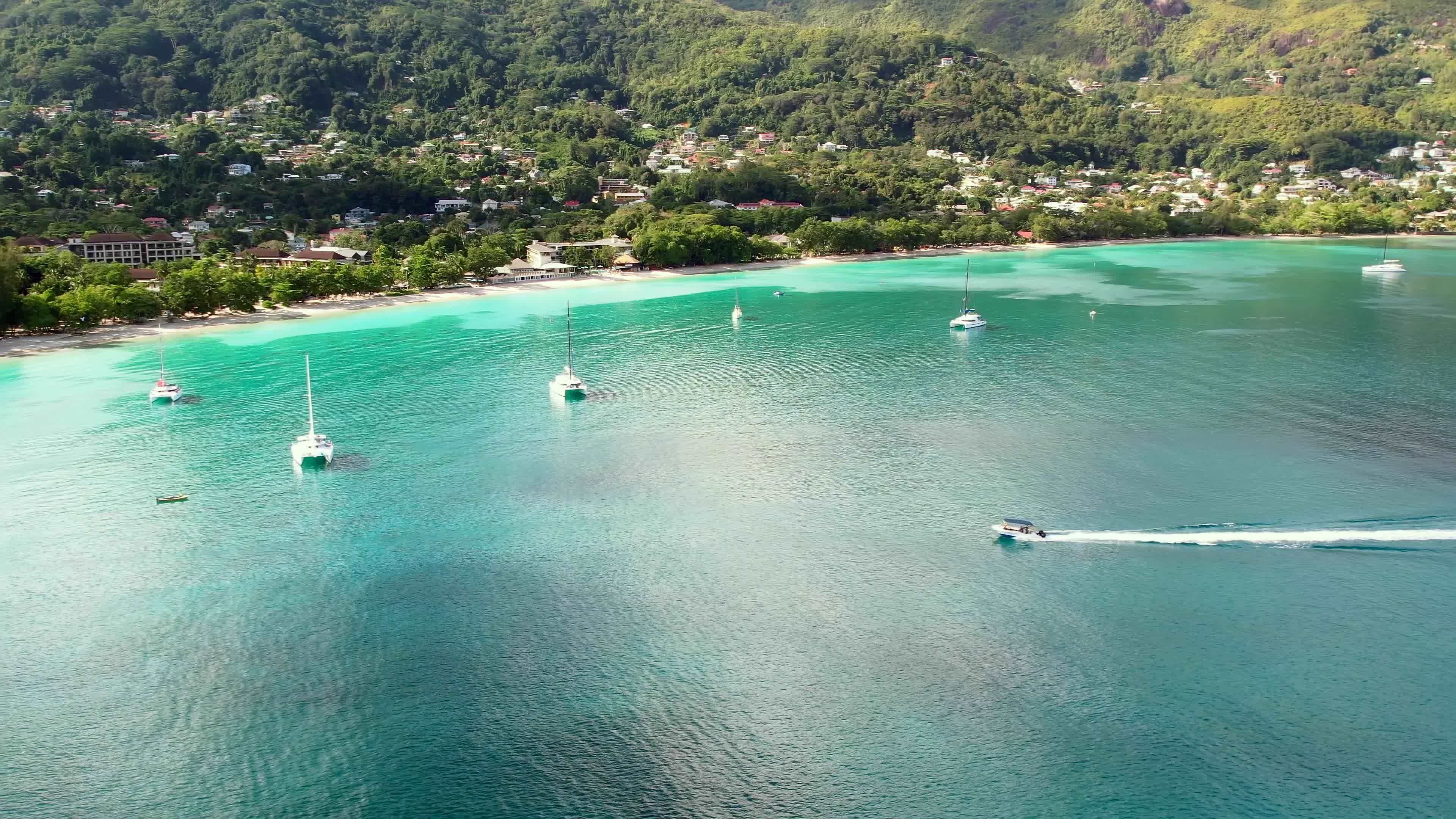 Boat from excursion approaching shore of Beau Vallon, docking sea