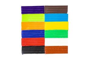 Multicolored plasticine, kids plasticine in the form of cubes and strips. White isolated background. photo