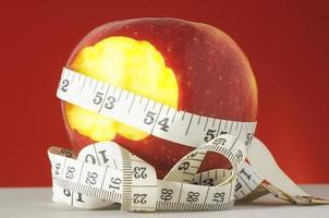 Red apple with measuring tape photo