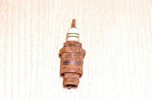 Rusty metal plug on white background photo