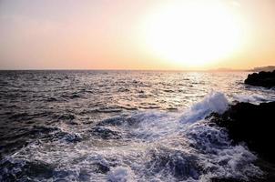 Waves hitting rocks photo