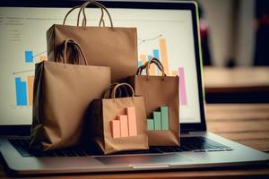 Shopping bags on laptop with paper boxes on table and sales data economic growth graph on screen photo