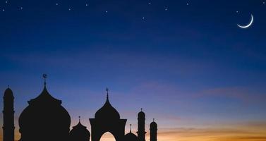 Silhouette Mosque domes with Crescent moon and stars on Twilight sky background in Iftar period during Ramadan Holy month photo