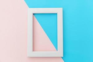 Simply design with empty pink frame isolated on pink and blue pastel colorful background. Top view, flat lay, copy space, mock up. Minimal concept. photo