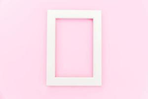 Simply design with empty pink frame isolated on pink pastel colorful background. Top view, flat lay, copy space, mock up. Minimal concept. photo
