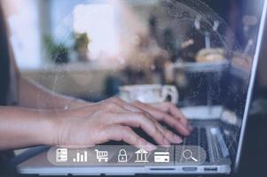 Business woman using laptop computer working at home, Female typing on keyboard notebook with virtual icon for upload or download application, online Banking, Technology transformation and sharing photo