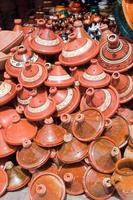 Traditional clay tajines to sell in a street market photo