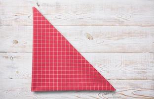 red table cloth on white wooden table photo