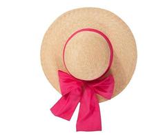 Pretty straw hat with ribbon and bow on white background. Beach hat top view isolated photo