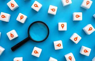 Magnifying glass and many red location pin places for visiting. Search for new places. Tourism and travel. Purchase, rent of housing, land market plots. Guide to interesting destinations. Navigation photo