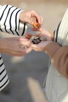 Closeup of child girl's hands giving many seashells to her young mother with love and tenderness. child and parents on a trip, the ocean seashore, hands of mother and daughter. High quality photo