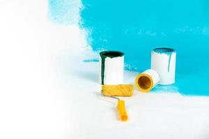 Instruments for renovation apartment room isolated on white and blue background. accessories for gluing, painting tools. Colorful paint cans. Concept of repair home. Copy space for advertisement photo