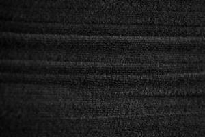 stacked black bathroom towels background. spa salon, barbershop photo