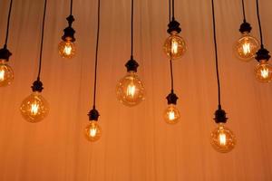 Edison light bulb background. Vintage lamps over concrete background. selective focus photo