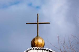 Orthodox church cross on a background of blue sky with clouds. Easter. Christmas. Place for text. Background image. Religion. selective focus photo