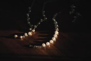 Close up of the wedding jewelry on wooden background photo