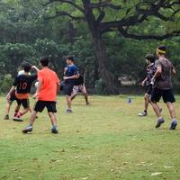 New Delhi, India - July 01 2018 -Footballers of local football team during game in regional Derby championship on a bad football pitch. Hot moment of football match on grass green field of the stadium photo