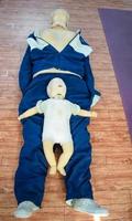 Human dummy lies on the floor during first Aid Training - Cardiopulmonary resuscitation. First aid course on CPR dummy, CPR First Aid Training Concept photo