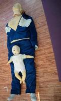 Human dummy lies on the floor during first Aid Training - Cardiopulmonary resuscitation. First aid course on CPR dummy, CPR First Aid Training Concept photo