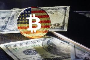 bitcoin dollars on a black background Golden bitcoins with the spotlight photo