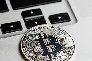 Silver bitcoin on a laptop photo