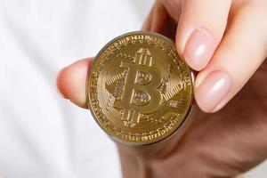 Isolated of hand putting a bitcoin concept human hand with bitcoin hand with bitcoin photo