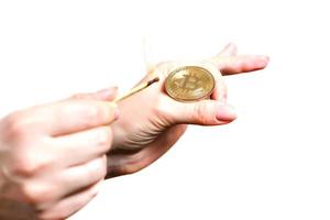 Bitcoin in hand on white background match, fire, flame, burning photo