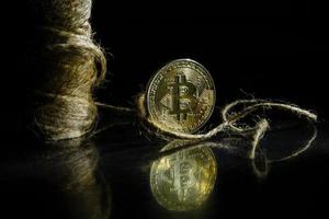 Golden bitcoin on black background with copy space cryptocurrency mining concept photo