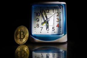 Gold bitcoin and vintage watch photo