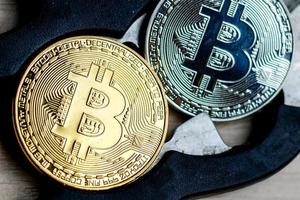 Physical version of bitcoin scissors and chain conceptual image for blockchain technology photo
