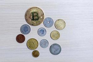 Golden bitcoin with international money coins new currency among old currencies business photo