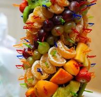 berries and fruit on skewers on a buffet table photo