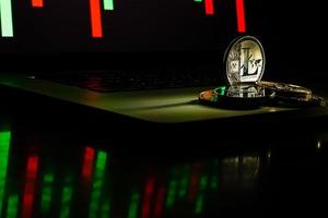 Bitcoin and litecoin on black laptop keyboard photo