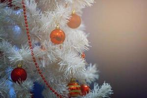 White Christmas decoration with balls on fir branches with blue background photo