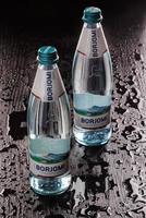 KRASNOYARSK, RUSSIA - OCTOBER 21, 2022 Two bottles of Borjomi natural mineral water on a black background.