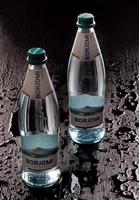 KRASNOYARSK, RUSSIA - OCTOBER 21, 2022 Two bottles of Borjomi natural mineral water on a black background.