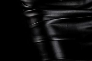 black leather skirt on a black background photo