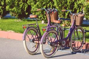 Vintag  bicycle with basket parked on the street retro wallpaper background shallow focus photo