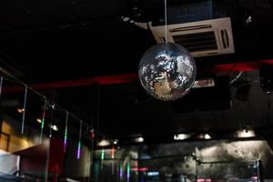 Disco ball with searchlight bright rays background night party photo