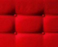 Closeup of a red cushion with buttons photo