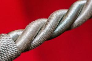Closeup detail of a rope over a solid red background photo