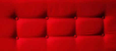 Closeup of a red cushion with buttons photo