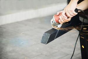 Man doing metal work using hand cutting machine tool photo