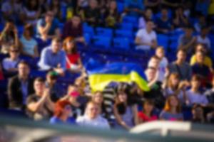 Blurred crowd of spectators on a stadium tribune at a sporting event photo